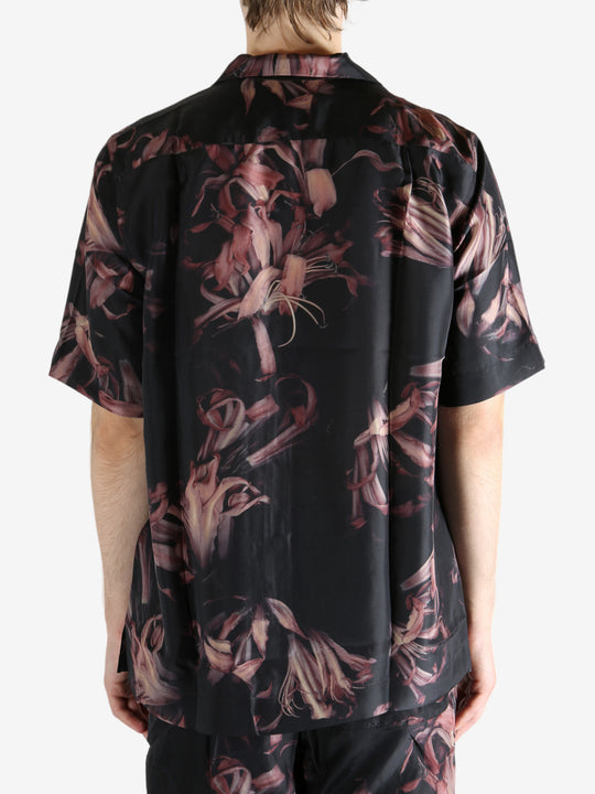 Black shirt worn by a person, showing the shirt's fit