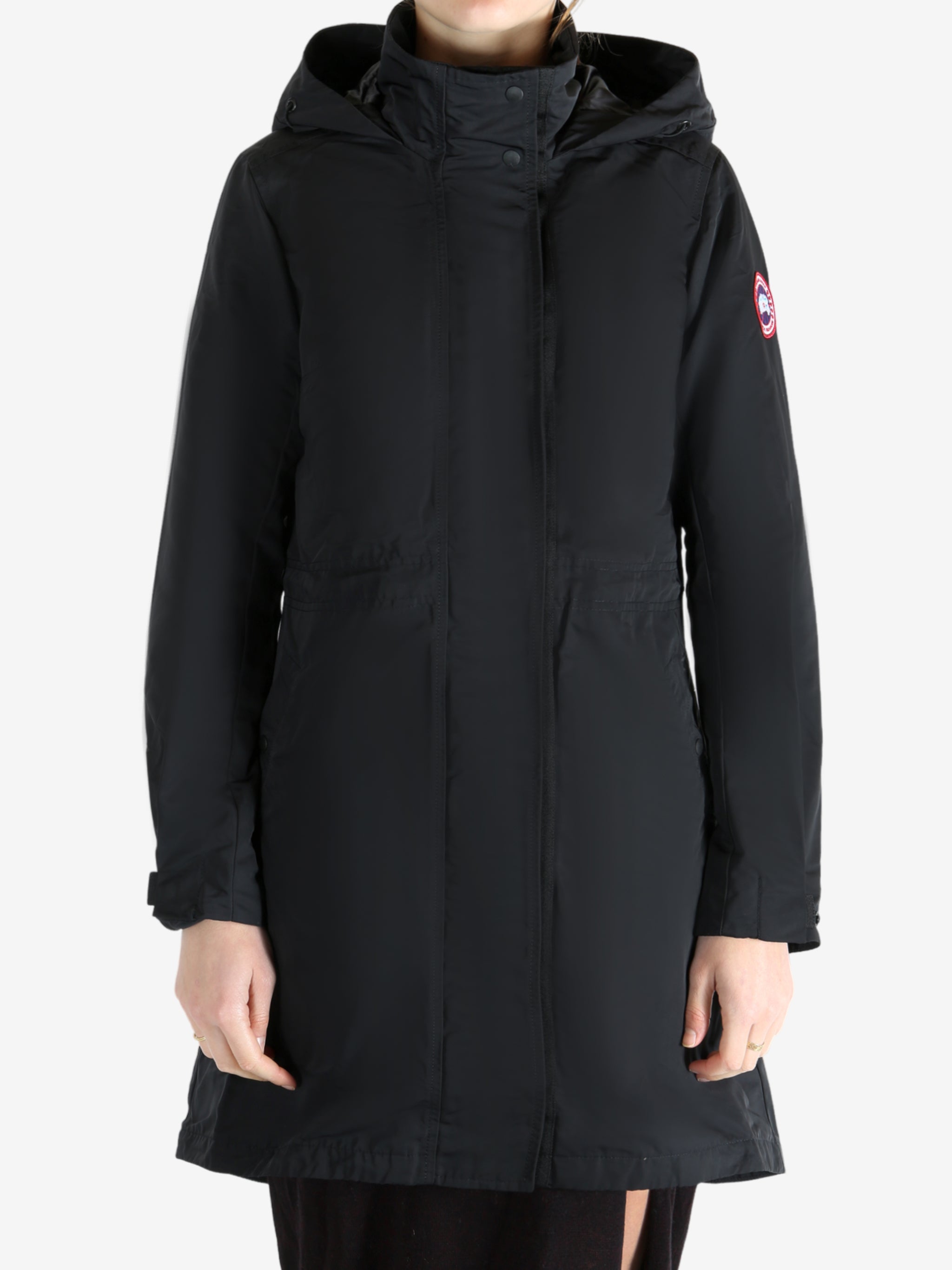 Black coat worn by a person, showing the coat fit