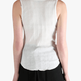White top worn by a person, showing the top's fit