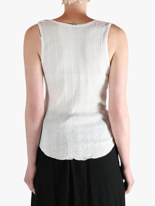 White top worn by a person, showing the top's fit
