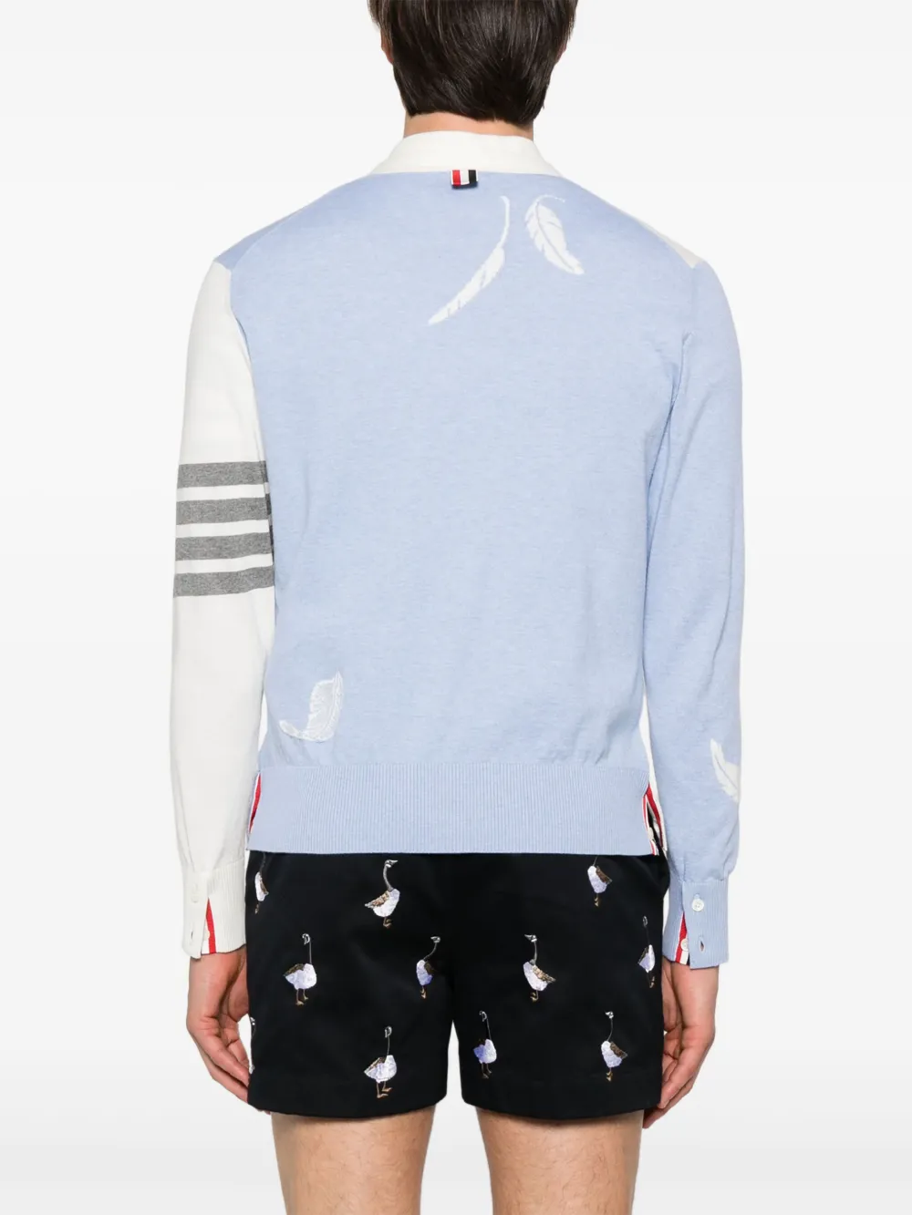 Blue knitwear worn by a person, showing the knitwear's fit