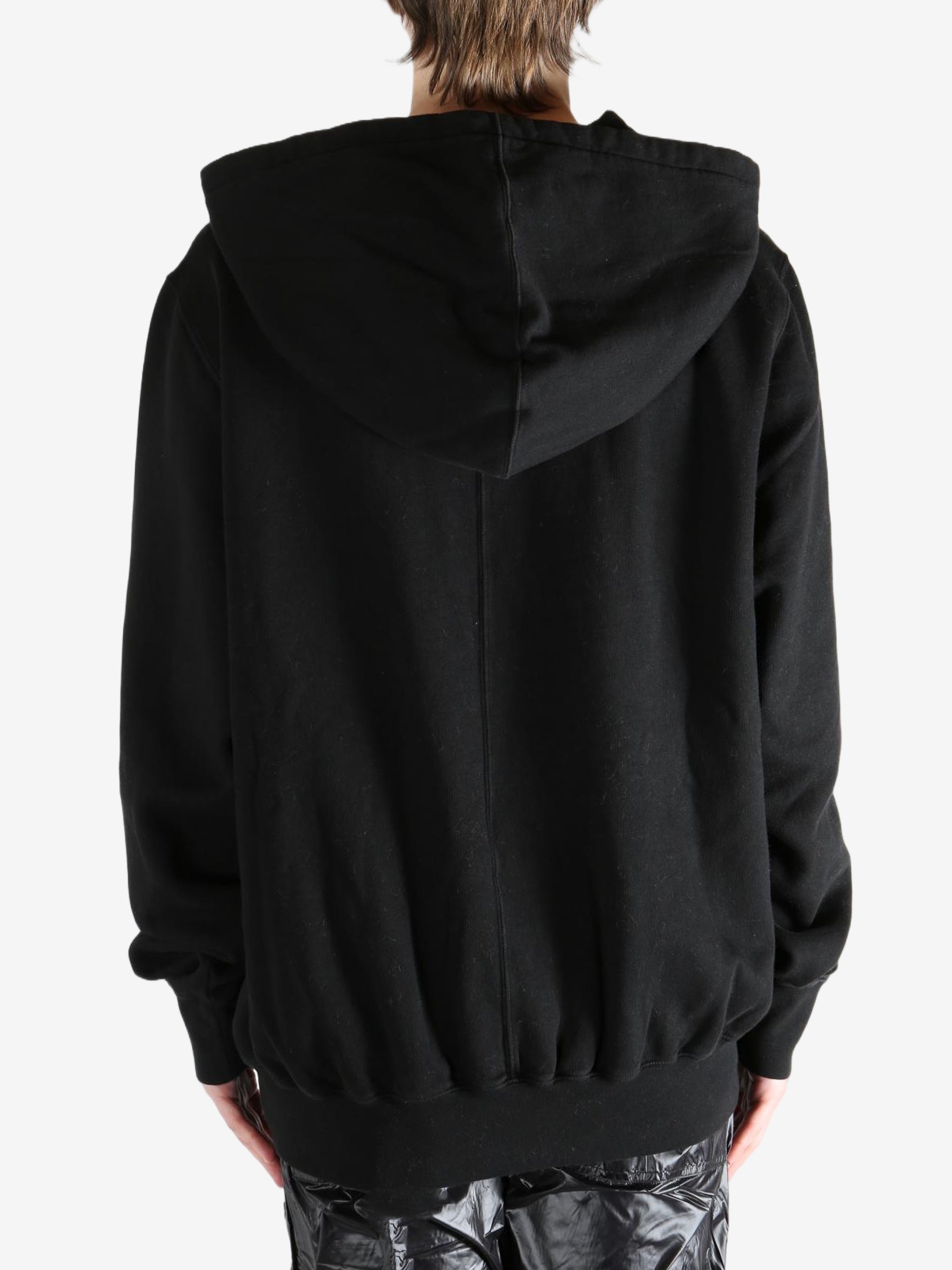 Black hoodie worn by a person, showing the hoodie's fit