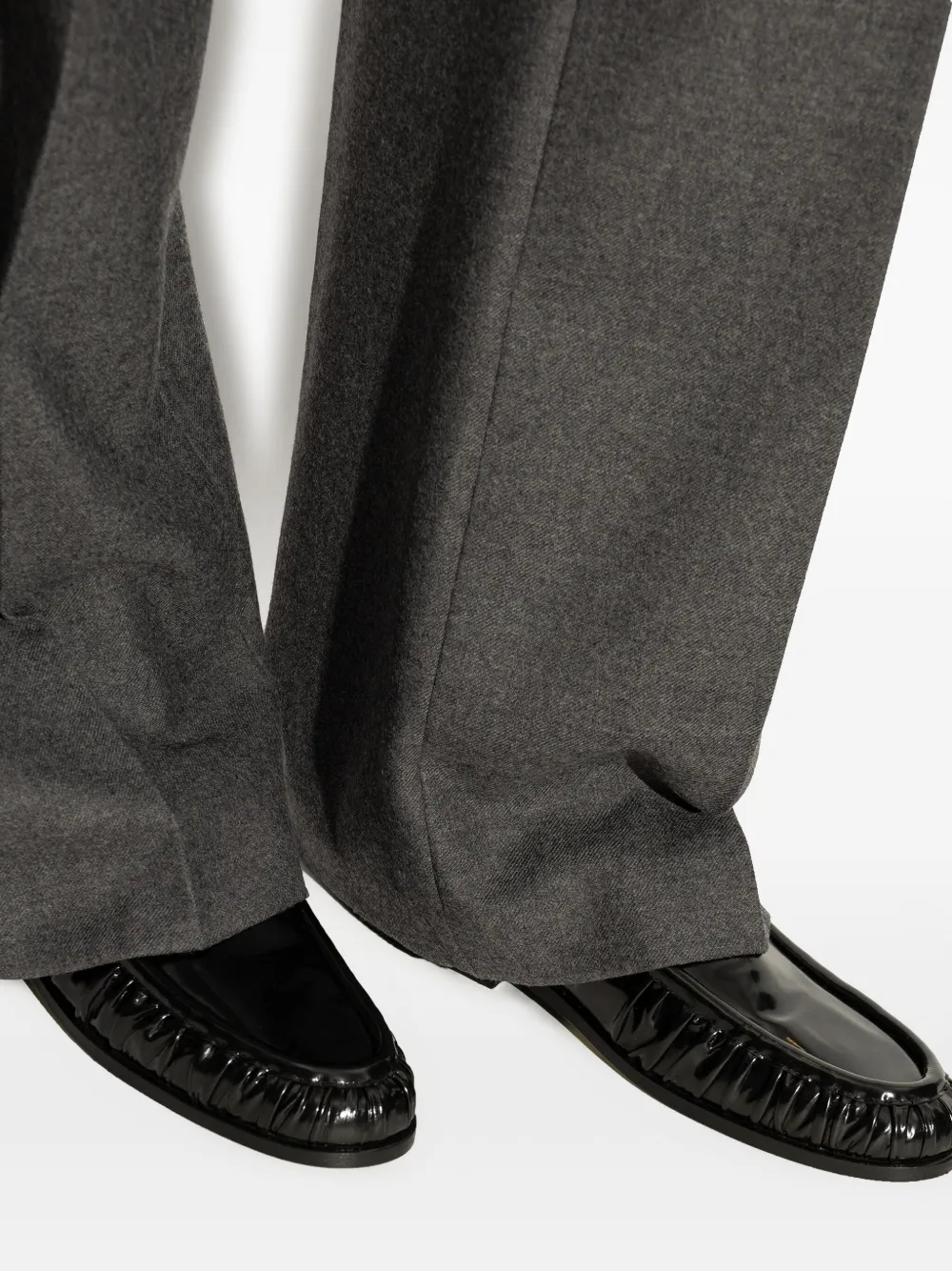 Black loafer worn by a person, showing the loafer's fit