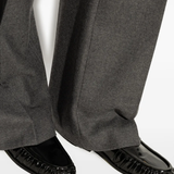 Black loafer worn by a person, showing the loafer's fit