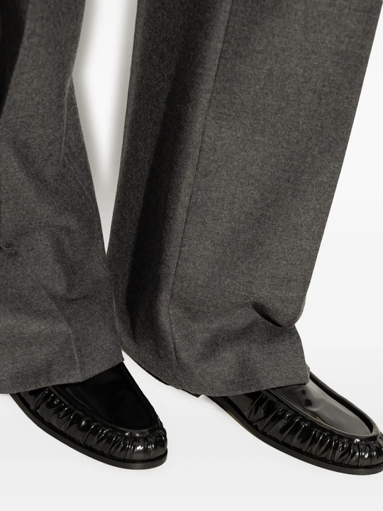 Black loafer worn by a person, showing the loafer's fit