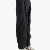 Black pants worn by a person, showing the pants fit