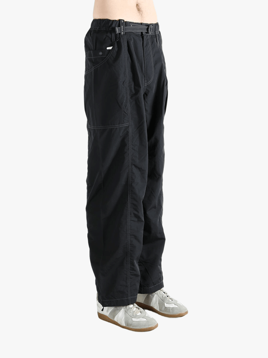 Black pants worn by a person, showing the pants fit