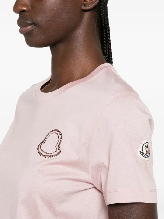 Pink t-shirt worn by a person, showing the t-shirt fit