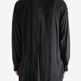 Black shirt worn by a person, showing the shirt's fit