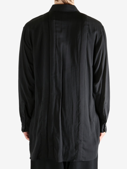 Black shirt worn by a person, showing the shirt's fit