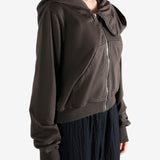 Brown hoodie worn by a person, showing the hoodie's fit