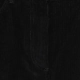 Close up of black pants, showing texture of the cotton fabric