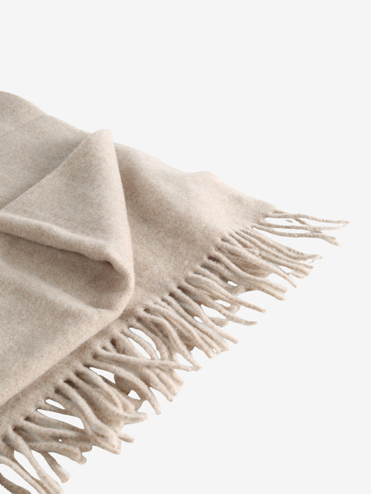 Close up of tan scarves, showing texture of the wool fabric