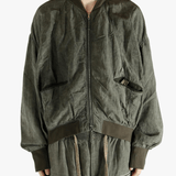 Green jackets worn by a person, showing the jackets fit