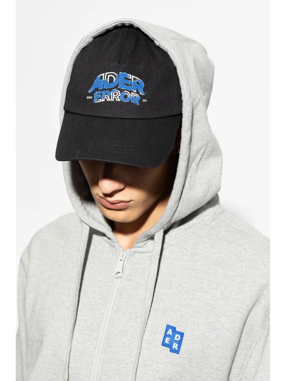 Black hats worn by a person, showing the hats fit