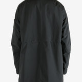 Black coat worn by a person, showing the coat fit