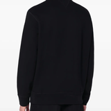 Black sweatershirt worn by a person, showing the sweatershirt's fit