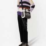 Black bag carried by a person, showing the bag's fit