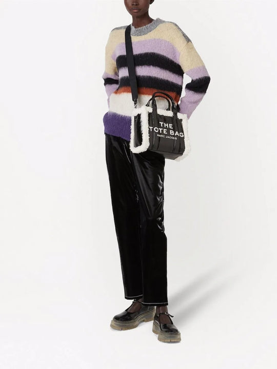 Black bag carried by a person, showing the bag's fit