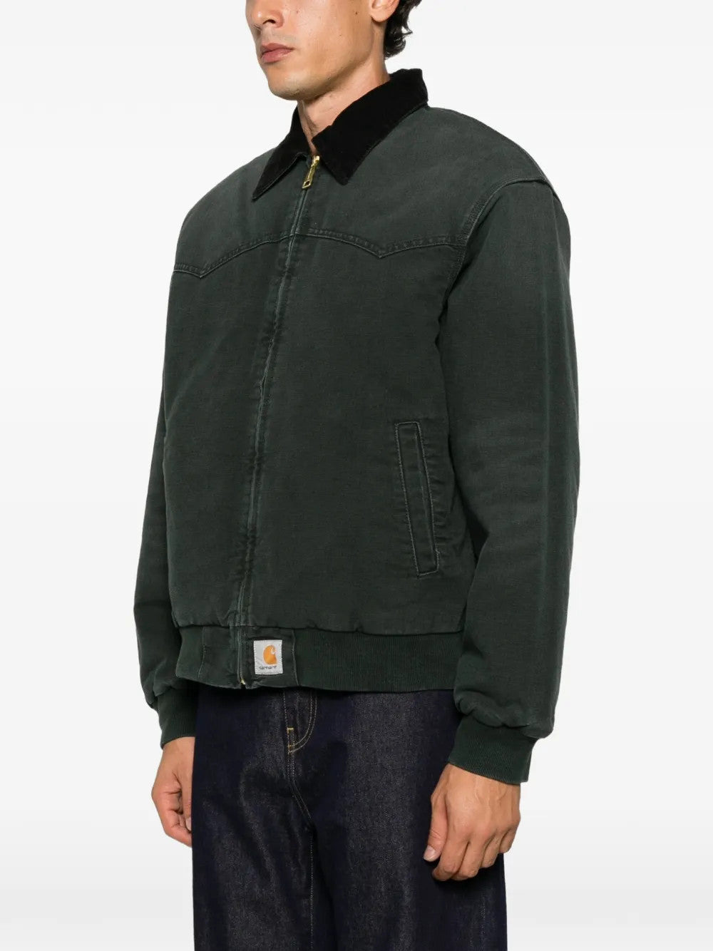 Green jacket worn by a person, showing the jacket fit