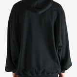 Black hoodie worn by a person, showing the hoodie's fit