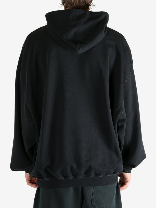 Black hoodie worn by a person, showing the hoodie's fit