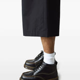 Black shoes worn by a person, showing the shoes fit