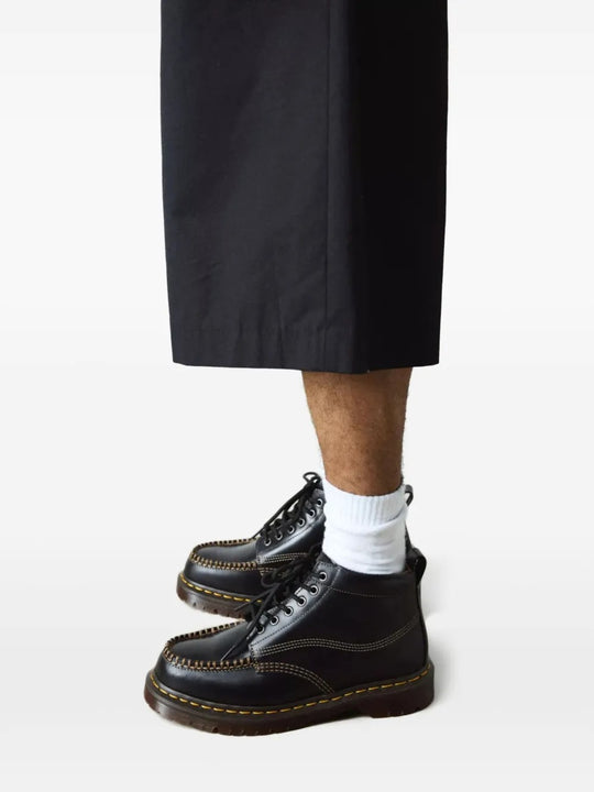 Black shoes worn by a person, showing the shoes fit