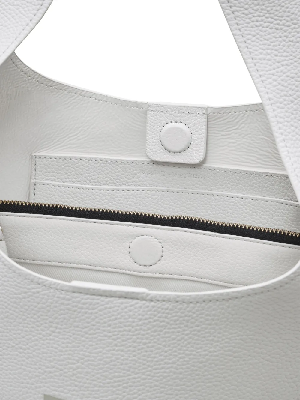 Close up of the white bag, showing texture of the leather fabric