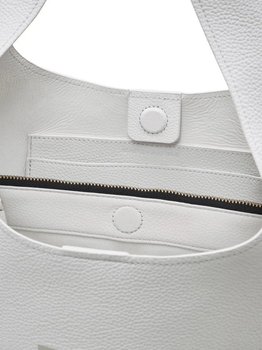 Close up of the white bag, showing texture of the leather fabric