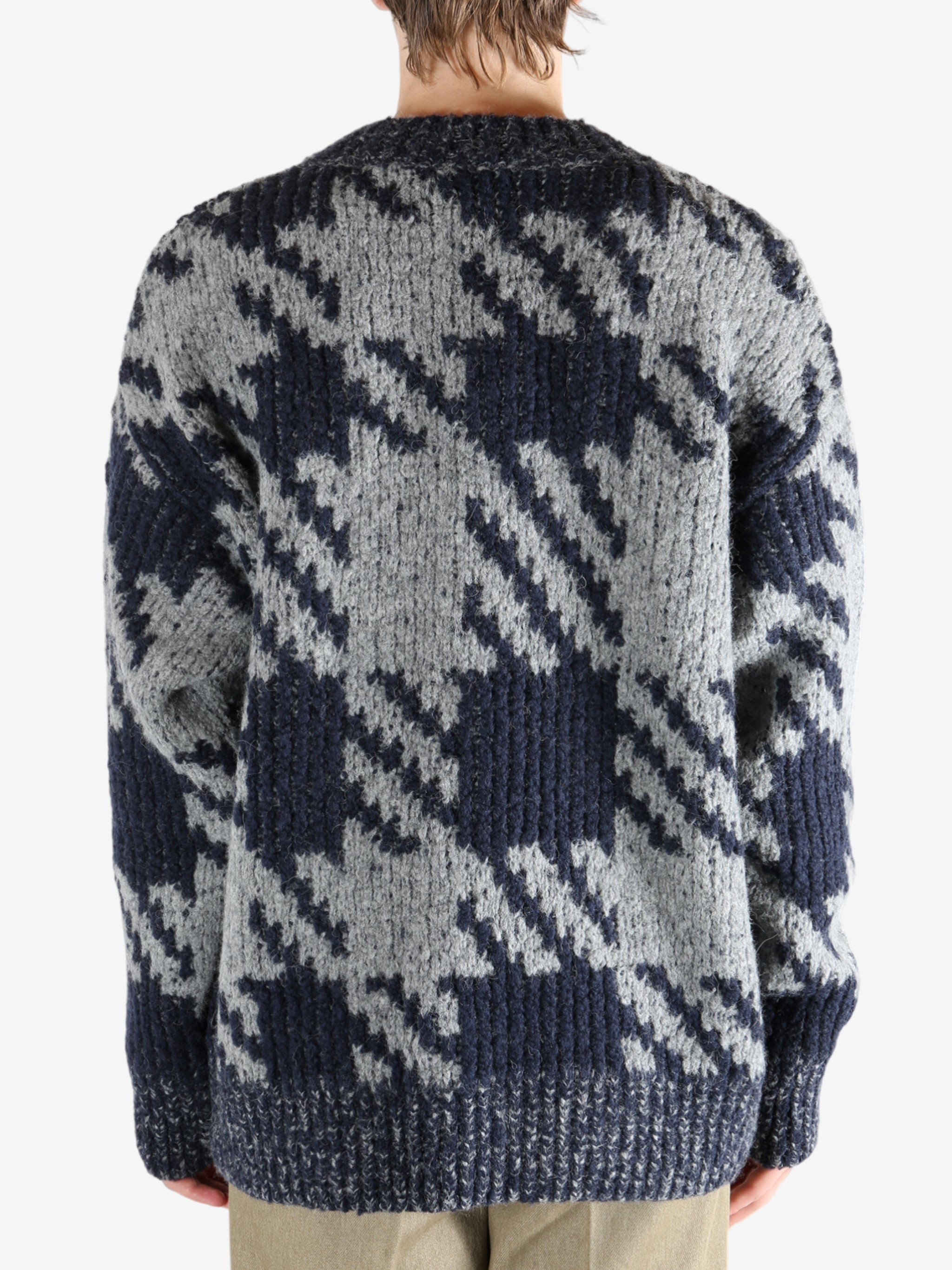 Blue sweater worn by a person, showing the sweater fit