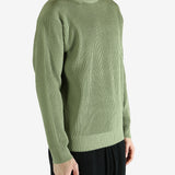 Green knitwear worn by a person, showing the knitwear's fit