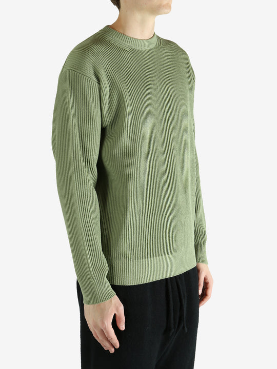 Green knitwear worn by a person, showing the knitwear's fit