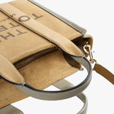 Close up of the brown bag, showing texture of the leather fabric