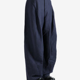 Navy pants worn by a person, showing the pants's fit