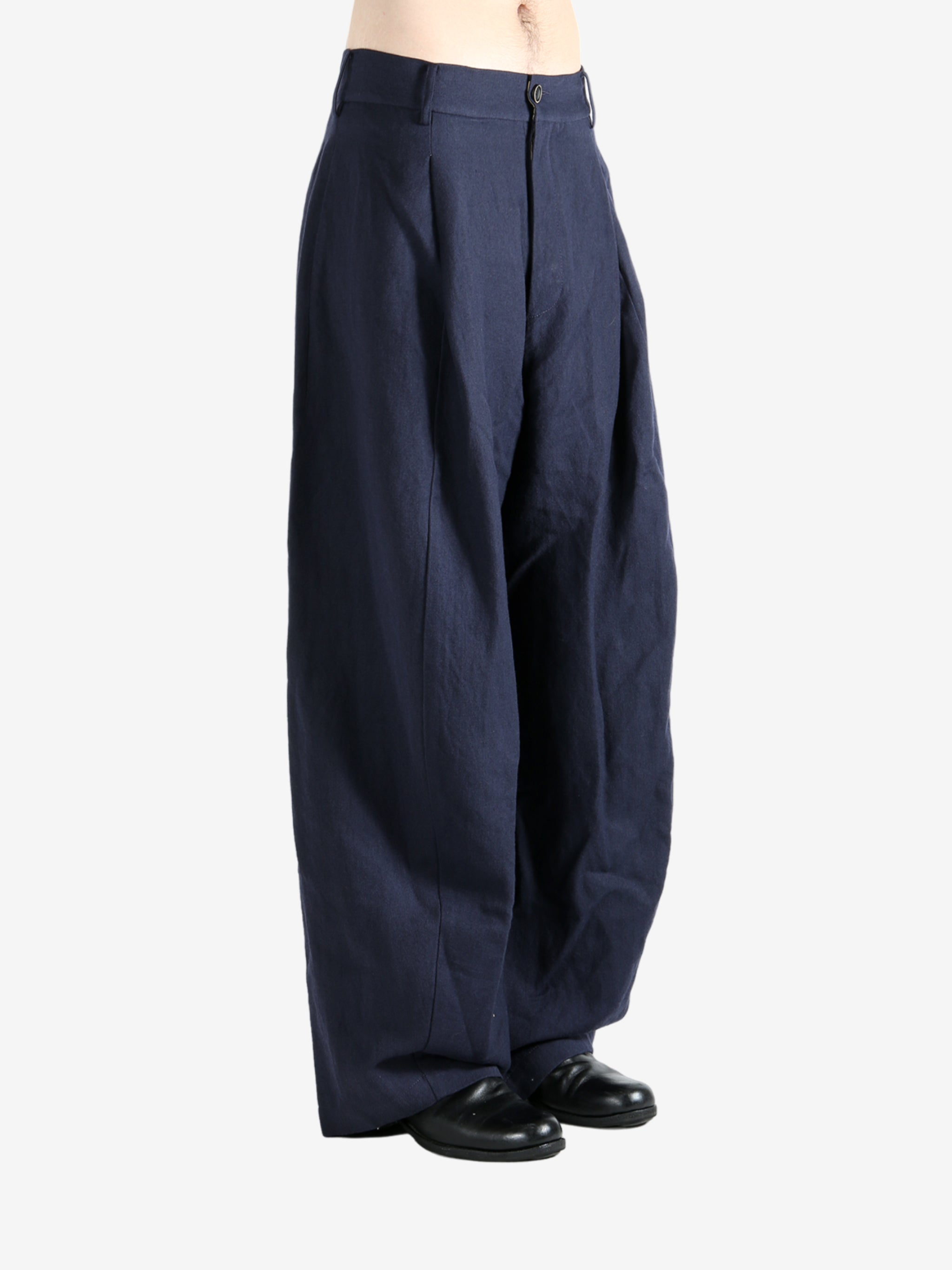 Navy pants worn by a person, showing the pants's fit