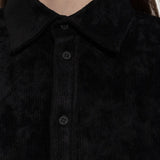 Close up of black shirt, showing texture of the viscose fabric