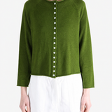 Green knitwear worn by a person, showing the knitwear fit