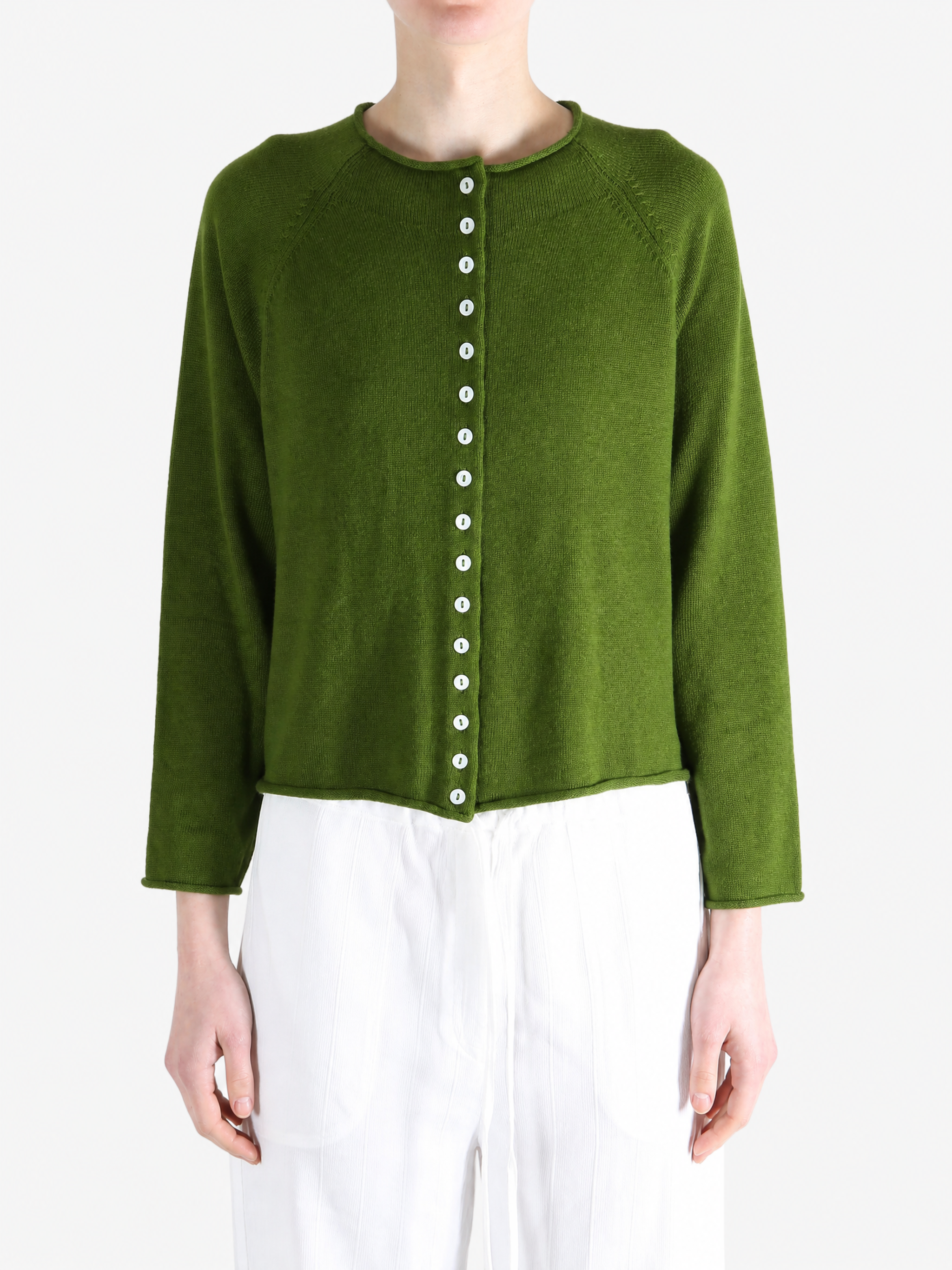 Green knitwear worn by a person, showing the knitwear fit
