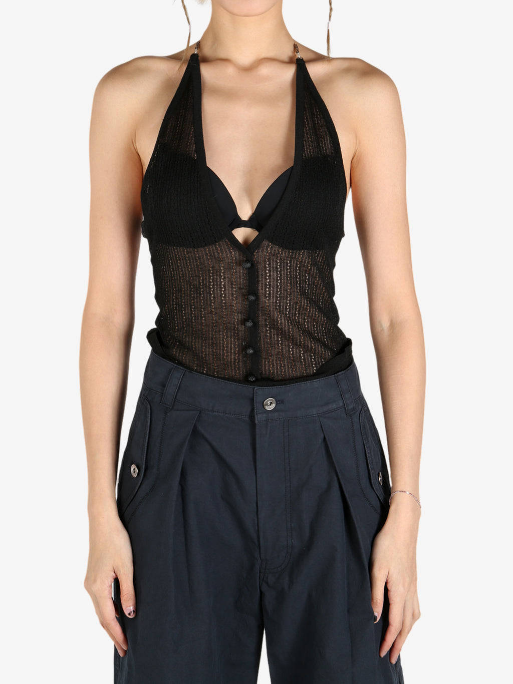 Black tops worn by a person, showing the tops fit