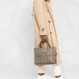 Grey bag carried by a person, showing the bag's size