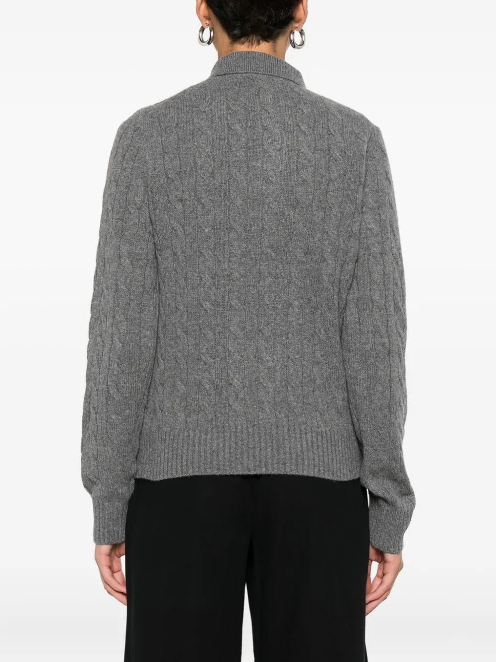 Grey knitwear worn by a person, showing the knitwear's fit