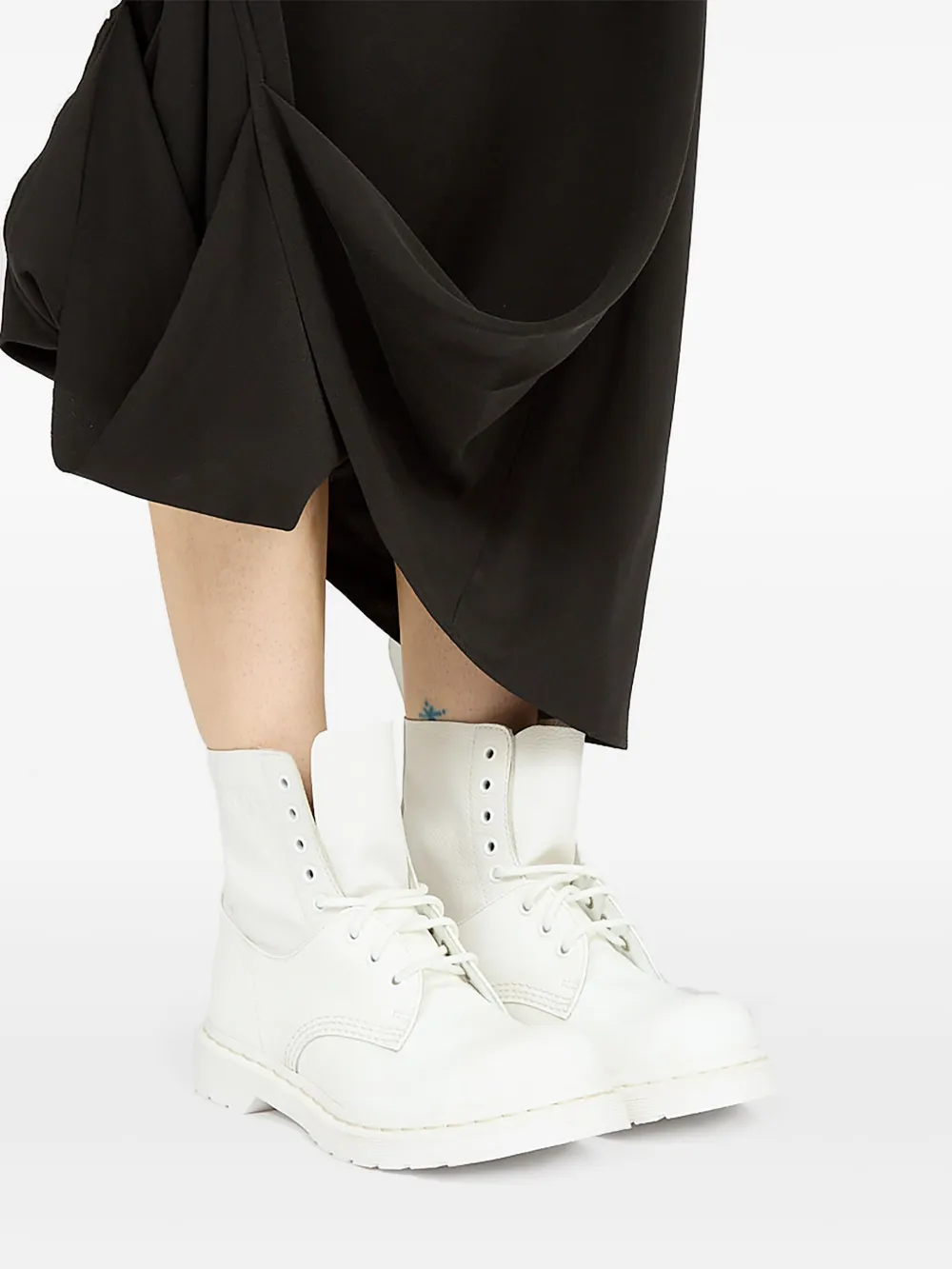 White boots worn by a person, showing the boots's fit