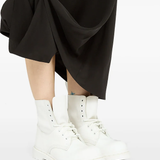 White boots worn by a person, showing the boots's fit