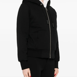 Black coat worn by a person, showing the coat fit