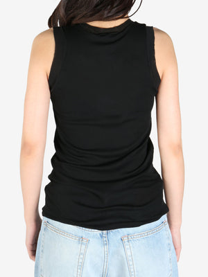 Black tee worn by a person, showing the tee's fit