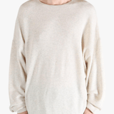 White sweater worn by a person, showing the sweater's fit