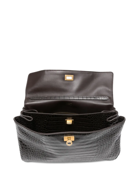 Close up of black bag, showing texture of the leather fabric