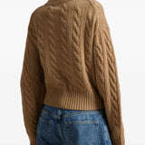 Brown knitwear worn by a person, showing the knitwear's fit