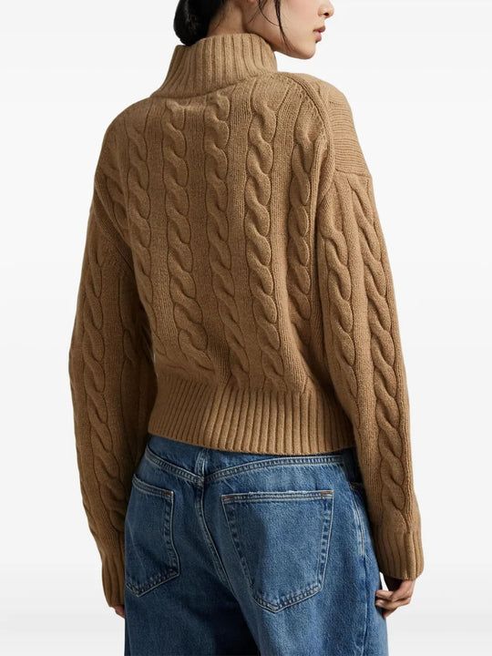 Brown knitwear worn by a person, showing the knitwear's fit
